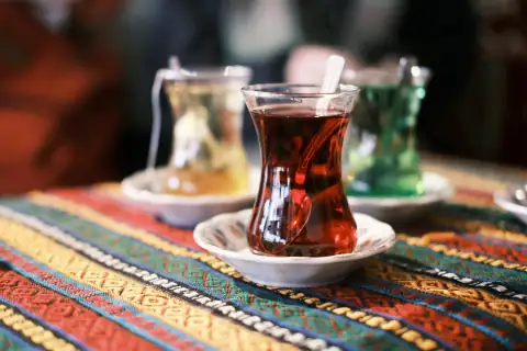 Mugs, cups & glasses: a cup of tea on a plate on a table