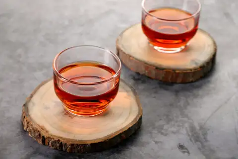 Mugs, cups & glasses: clear glass cup with red liquid on brown wooden table