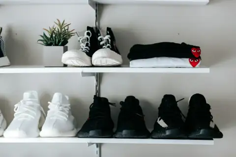 Shoe racks: three pairs of black and white shoes on floating shelf