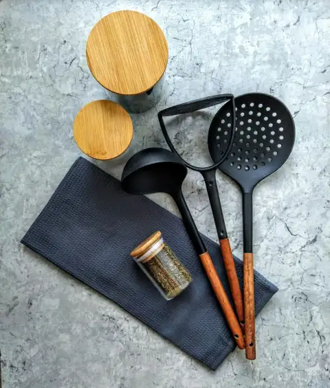 Kitchen tools: brown wooden spatula beside black handled spatula