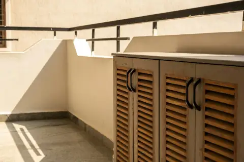 Shoe racks: a row of wooden lockers sitting on top of a cement floor