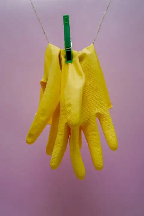 Gloves: yellow gloves on blue clothes hanger