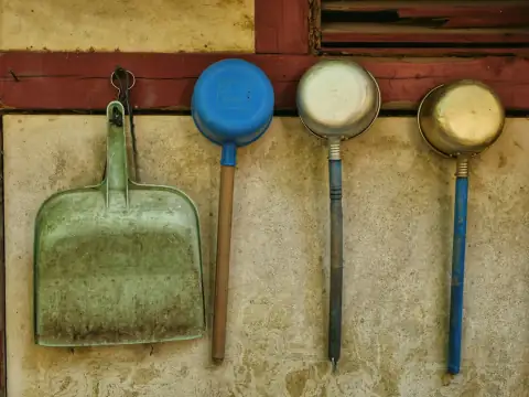 Dustpans: Dustpan and ladles hanging on a wall