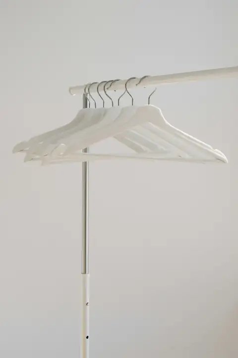 Hangers & clips: white clothes hangers hanging on rack