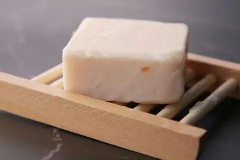 Bathroom accessories: a block of soap sitting on top of chopsticks
