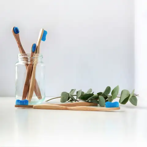 Combs & grooming: blue and white toothbrush in clear glass jar