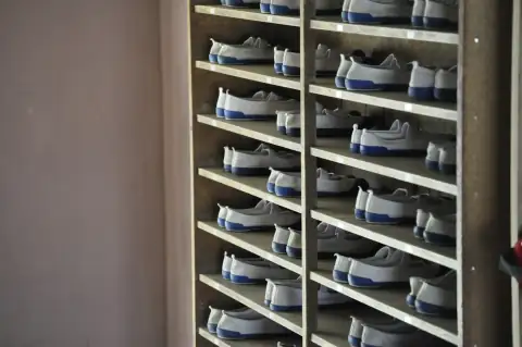 Shoe racks: white and blue shoes in rack inside room