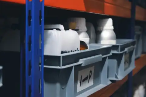 Racks: a shelf filled with lots of white and orange containers