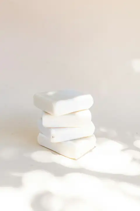 Bathroom accessories: white soap on white table