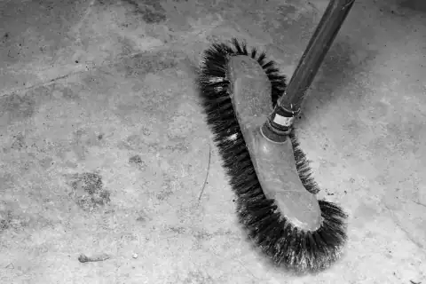 Floor wipers: A stiff-bristled brush on a concrete floor
