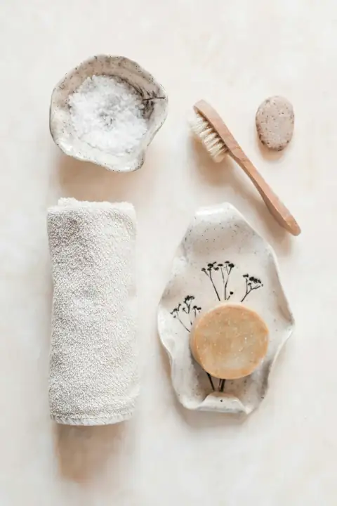 Bathroom accessories: white and brown wooden rolling pin