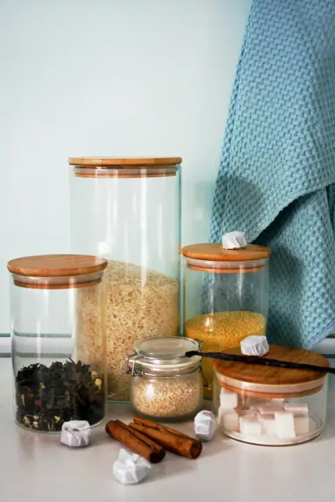 Containers & jars: a table topped with jars filled with food