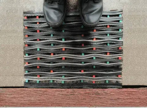 Doormats: a pair of black shoes sitting on top of a pile of shoes