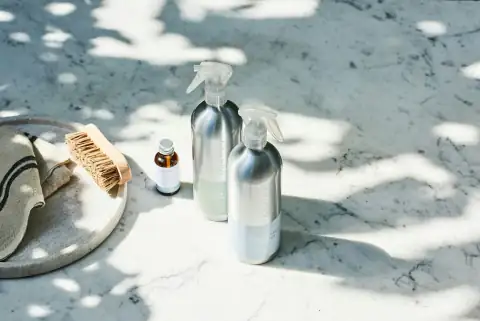 Phenyl & cleaners: a group of bottles and a rope on a snowy ground