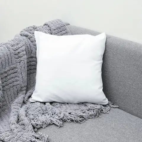 Pillows: white throw pillow on gray sofa