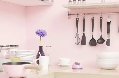Kitchen tools: a pink kitchen with utensils hanging on the wall